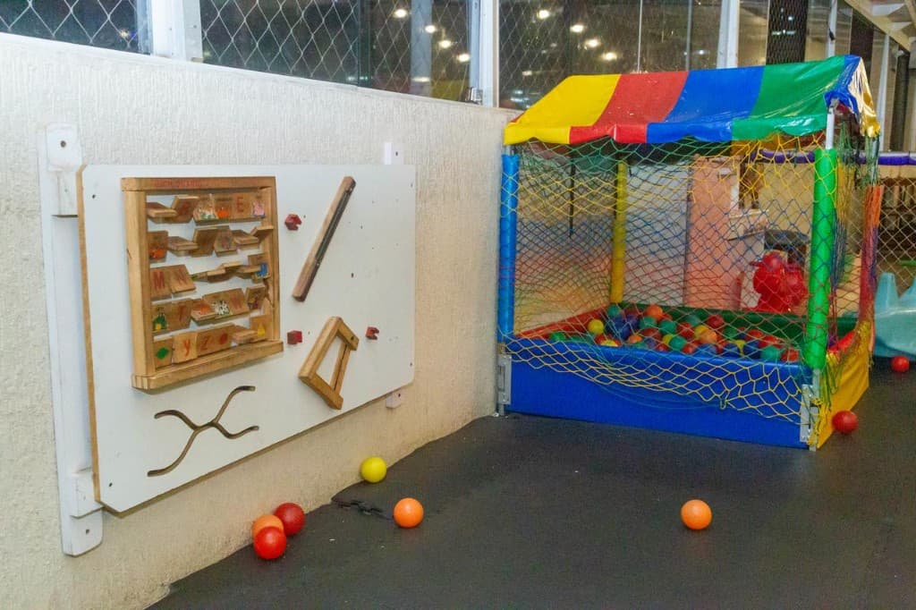 Brinquedão infantil com redes coloridas e escorregador roxo no Play Bar.